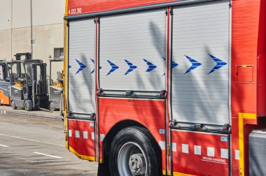 Viladecanlar. İspanya - 15 Kasım 2024: İtfaiye aracı acil müdahale için şehir caddesine park edildi. Kırmızı itfaiye aracı, şehir güvenliğinin hayati bir parçası. İtfaiyecilerin hazır olduklarını gösteriyor..