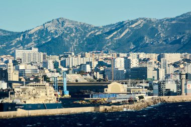 Marseille, France - December 05, 2024: Stunning skyline of Marseille with modern skyscrapers and majestic mountains, highlighting the city's unique blend of nature and contemporary architecture. clipart