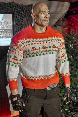 Madrid, Spain - January 16, 2025: Wax figure of Dwayne Johnson with detailed outfit on display at the Madrid Wax Museum. Ideal for film and entertainment themes. clipart