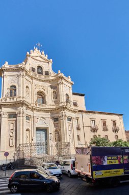 Catania, İtalya - 25 Şubat 2025: Sicilya, Catania 'daki büyük bir katedral, açık mavi bir gökyüzünün altında, barok mimari ve şehir cazibesini sergiliyor. Kavram: Sicilya mimari güzelliği