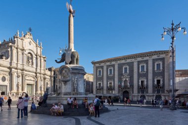 Catania, Italy - March 3, 2025: Catania's Piazza del Duomo with its elephant statue and the Cathedral of Saint Agatha and tourists. For travel guides, articles on Sicilian heritage and architectural. clipart