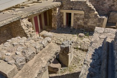 Turistler, antik Yunanistan 'ın mirasını anlatan mimari unsurları gözlemleyerek Knossos Sarayı' nın kalıntılarını keşfediyorlar..