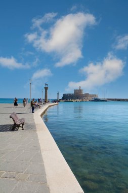 Rodas.Yunanistan - Haziran 04, 2025: Rodos 'un ikonik limanının manzarası, antik simgeleri çağdaş eğlence ve huzurlu Akdeniz ile harmanlıyor.