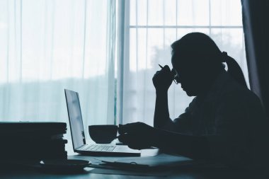 Stress business woman person from hard work, depression in office. Tired and anxious employee female with unhappy at problem job. young businesswoman sitting sad front of laptop computer on desk.