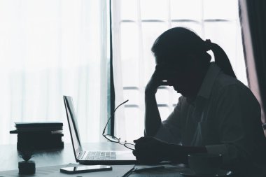 Stress business woman person from hard work, depression in office. Tired and anxious employee female with unhappy at problem job. young businesswoman sitting sad front of laptop computer on desk.