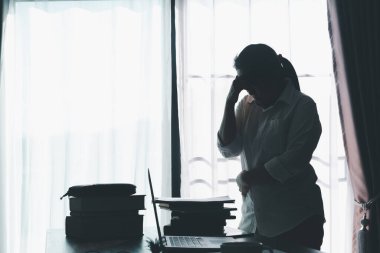 Stress business woman person from hard work, depression in office. Tired and anxious employee female with unhappy at problem job. young businesswoman sitting sad front of laptop computer on desk.