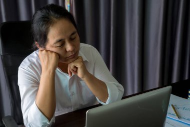 Stress business woman person from hard work, depression in office. Tired and anxious employee female with unhappy at problem job. young businesswoman sitting sad front of laptop computer on desk.