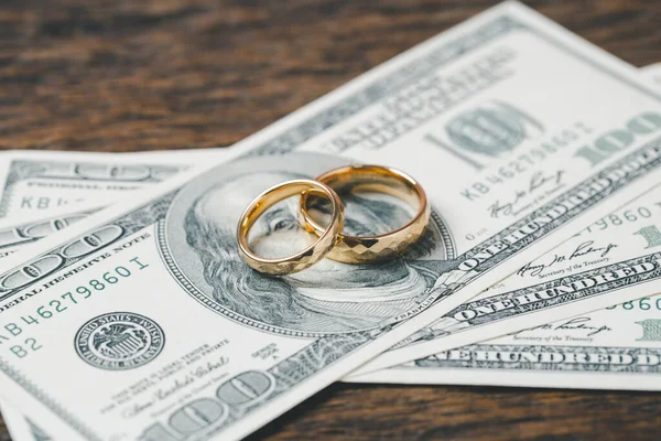 Save money and planning wedding concept. Sustainable financial goal for family life or married life. Rings with stack of coins, saving money for marry, depicts savings or growth for new family.