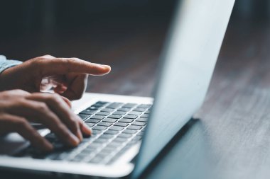 Woman person hands with laptop computer on wooden table for business or technology background.