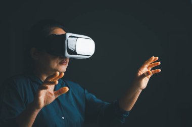 Woman with glasses of virtual reality. Future technology concept. Metaverse technology concept. VR virtual reality goggles. Futuristic lifestyle. female using virtual reality headset at home office.