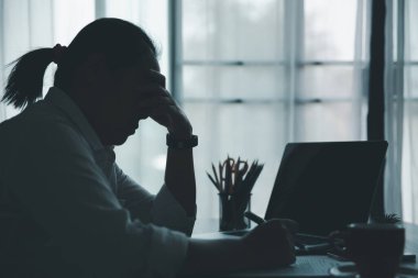 Stress business woman person from hard work, depression in office. Tired and anxious employee female with unhappy at problem job. young businesswoman sitting sad front of laptop computer on desk.