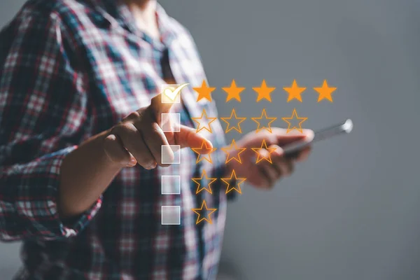 Customer experience with customer service and satisfaction concept. Woman finger touching on five star excellent rating on background, copy space, Customers show satisfaction and quality of services.