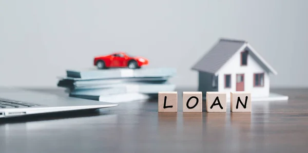 Car, house, personal money loan concept. finance business icon on wooden cube. saving money for a car. money and House. Wooden cubes with word loan. Copy space for text. Loan payment car and house.