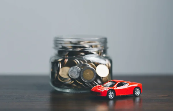 Car and house model with coins and financial document on wooden table. Asset approval concepts purchases to buy a car and a house. Ideas for home buying checklist home loan tax