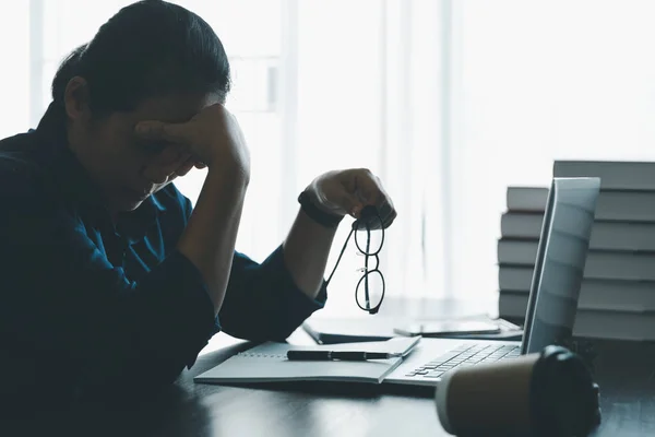 stock image Stress business woman person from hard work, depression in office. Tired and anxious employee female with unhappy at problem job. young businesswoman sitting sad front of laptop computer