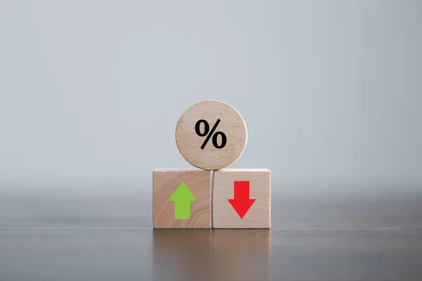 Closeup wood cubes with percentage symbol, Percent and upwards increasing arrows on wooden cubes. Financial interest mortgage rates increase or price commission raise, growth business, finance tax.