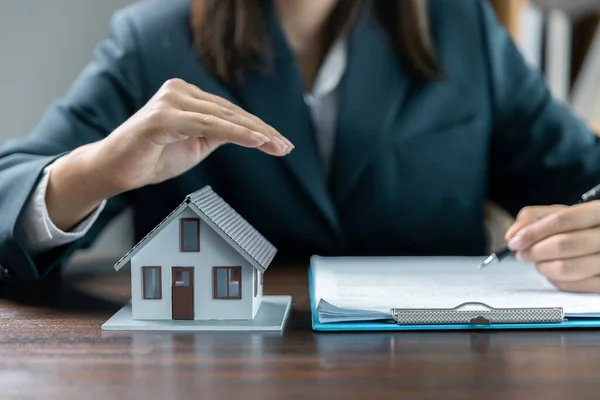 Banks approve loans to buy homes. Real estate agents explain the document for customers who come to contact to buy a house, buy or sell real estate concept.
