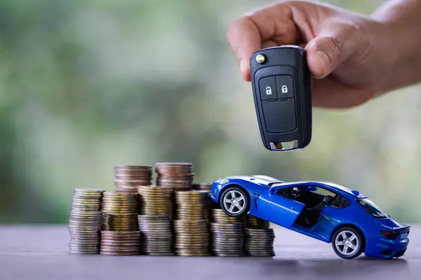Car dealers or insurance managers cover and protect against damage and risk of driving,Hold car keys,Protecting and after-sales care concept.successful car loan contract buying or selling new vehicle.