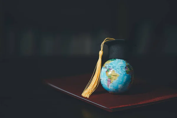 Graduated study abroad international Conceptual, Graduation hat on top Earth globe model map.Congratulations to graduates, Studies lead to success in world wide.Back to School. credited world by NASA