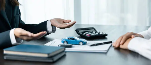 Business concept, car insurance, sell and buy car, car financing, car key for vehicle sales agreement. A car dealer is explaining to customers about loans with rental car insurance. Buying a car.