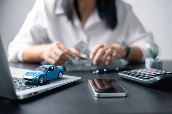 Concept of car insurance business, saving buy - sale with tax and loan for new car. Car toy vehicle with stack coin money on background. Planning to manage transportation finance costs. loan for car