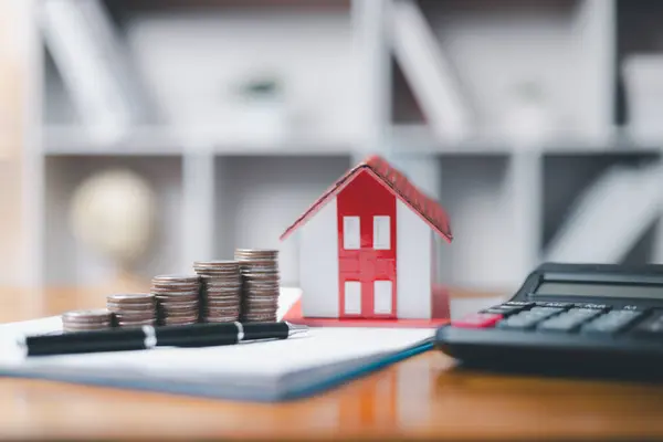 House model and money coins saving for concept saving money for buying a house, investment mortgage finance, and home loan refinance financial plan home. Property insurance and tax money.