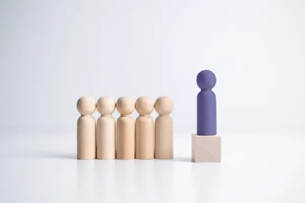 Wooden figure standing on the box for show influence and empowerment. Concept of business leadership for leader team, successful competition winner and Leader with influence