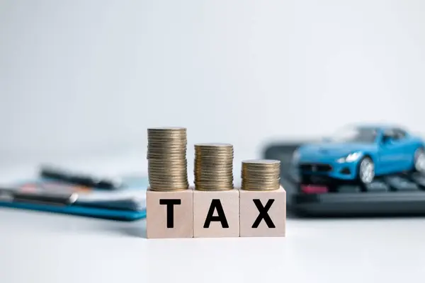 Car tax concept.close up stack of coins and tax wooden text with toy car.saving money for transport, manage for success business. Planning to manage transportation finance costs.