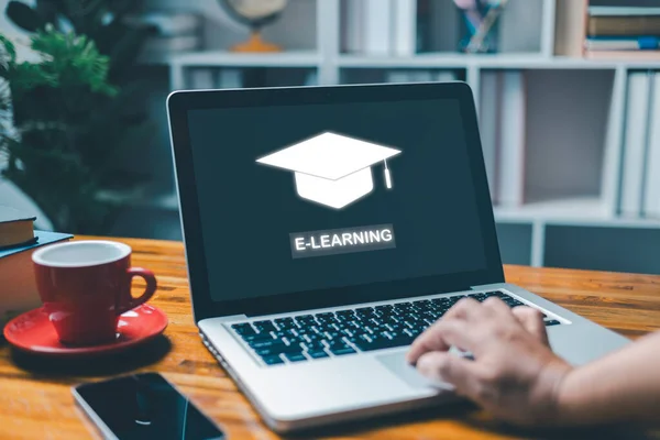 E-learning and online education for student and university concept. Laptop with inscription on screen e-learning, image of academic cap, technology to carry out digital training course for student