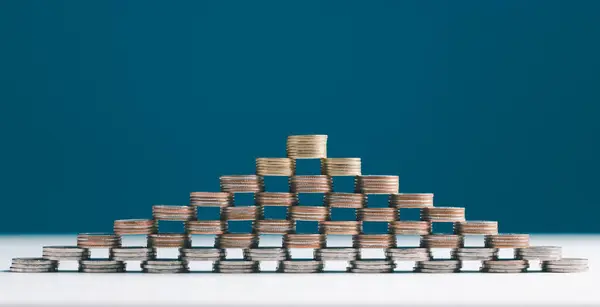 Coin stacks on a blue background. Coins stack for a financial business presentation background, home loan, money saving, stock and fund management, retirement plan concept, business growth, profit.