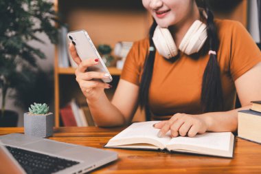 Uzak bir toplantıyla Asyalı ev okulu öğrencisi okul öğretmeninden sanal internet dersini öğreniyor. Kadın kulaklıkla matematik öğretiyor. Eğitim konsepti. Okulda bilgisayar eğitimi alan bir öğrenci.