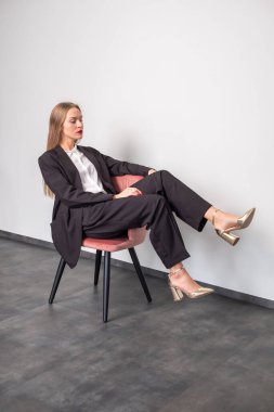 Kırmızı dudaklı ve kırmızı tırnaklı zarif bir iş kadını.