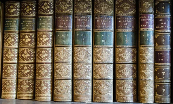 Vintage, leather-bound history books including volumes of Macaulay\'s History of England and Trevelyan\'s accounts of Garibadi.