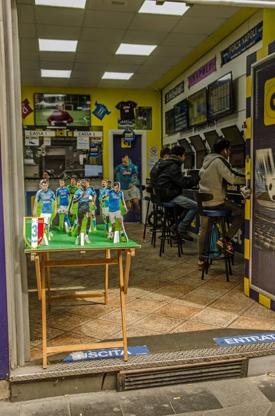 stock image Naples, Italy - April 2, 2023:  Small cardboard models of players in the SSC Napoli team decorating a betting shop in the Centro Storico area of Naples City Centre.  The city is celebrating the success of the football team which is set to win the Ser