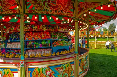 The colourful hook a duck stall at the vintage Carters Steam Fair during its late summer visit to the War Memorial Park in Basingstoke, Hampshire clipart