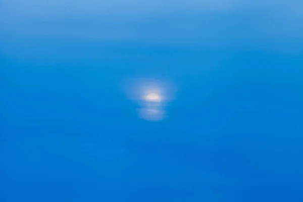 abstract moon hidden beyond the clouds