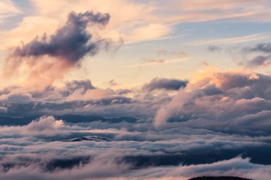 colored storm, fog and clouds on the valley at sunset