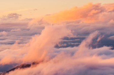 colored storm, fog and clouds on the valley at sunset