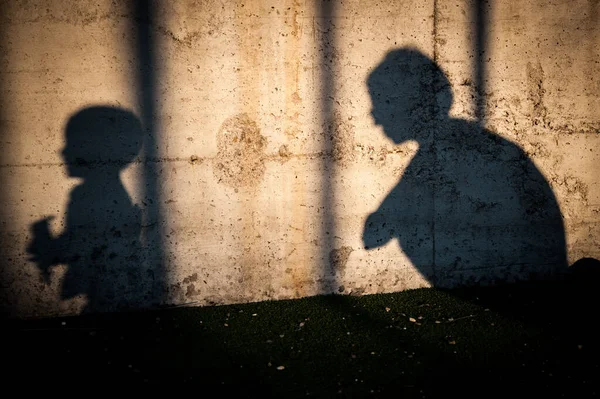 mom and son shadows on wall