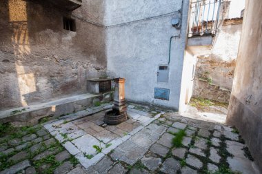ancient rusty iron fountain in the historic center