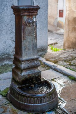 ancient rusty iron fountain in the historic center