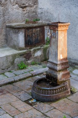 ancient rusty iron fountain in the historic center