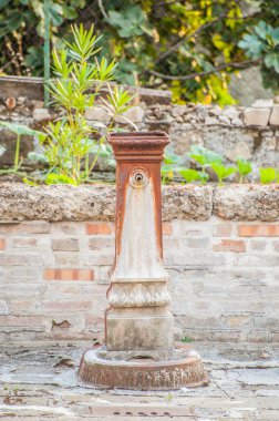 ancient rusty iron fountain in the historic center