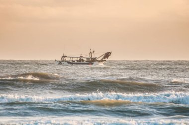 fishing boat come out at dawn