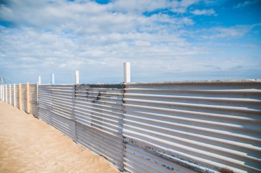 fence on the  beach in winter time 
