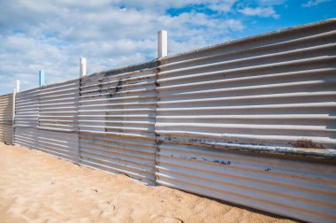 fence on the  beach in winter time 