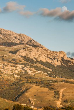 moon in the sky on the mountain villages at sunset