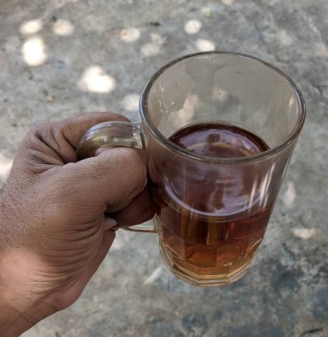 Bira bardağını tutan bir insan elinin yakın çekimi.