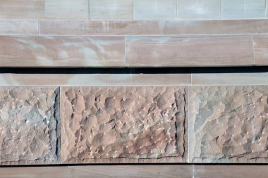 Split and processed red natural stone is used in construction