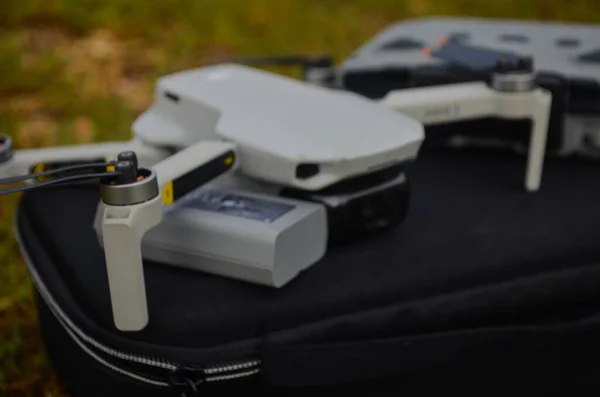 stock image MALANG, INDONESIA - November 6th 2022, Top view of the grey DJI Mini 2 drone and remote above the bag and in nature